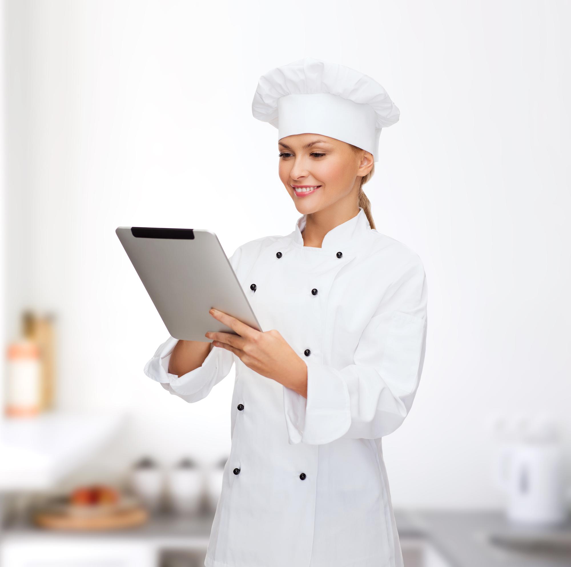 Chef using tablet in modern kitchen